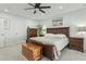 Bright main bedroom features dark wood furniture, ceiling fan, and neutral decor at 902 W Claremont St, Phoenix, AZ 85013