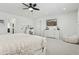 Bright main bedroom with a ceiling fan, plush carpet, TV, and makeup vanity at 902 W Claremont St, Phoenix, AZ 85013
