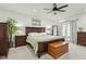 Spacious main bedroom features dark wood furniture, ceiling fan and access to patio at 902 W Claremont St, Phoenix, AZ 85013