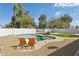 Backyard featuring a kidney shaped pool, artificial turf and lounge chairs at 902 W Claremont St, Phoenix, AZ 85013
