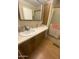 Well-lit bathroom featuring a vanity with wooden cabinets and a framed mirror above the sink at 1147 S Sioux Dr, Apache Junction, AZ 85119