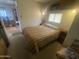 Functional bedroom featuring a cozy bed, built-in storage, and a bright, airy atmosphere at 1147 S Sioux Dr, Apache Junction, AZ 85119