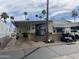 Charming mobile home featuring a covered carport, palm trees, and a well-maintained exterior at 1147 S Sioux Dr, Apache Junction, AZ 85119