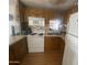Functional kitchen featuring white appliances, wood cabinets and laminate floor at 1147 S Sioux Dr, Apache Junction, AZ 85119