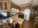Compact kitchen featuring ample cabinetry, essential appliances, and an adjacent breakfast bar at 1147 S Sioux Dr, Apache Junction, AZ 85119