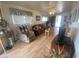Comfortable living room featuring a ceiling fan, large windows, and neutral decor throughout at 1147 S Sioux Dr, Apache Junction, AZ 85119