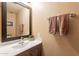 Bathroom featuring a new sink, countertop and dark wood mirror frame at 11731 N 91St Pl, Scottsdale, AZ 85260