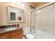 Bathroom featuring a wood vanity with granite counters and tiled shower/tub combo at 11731 N 91St Pl, Scottsdale, AZ 85260