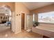 Bright bathroom with soaking tub, walk-in shower, and view from the windows at 11731 N 91St Pl, Scottsdale, AZ 85260
