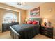 Comfortable bedroom with a large window and dark furniture at 11731 N 91St Pl, Scottsdale, AZ 85260