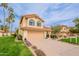 Charming two-story home featuring a well-manicured lawn, desert landscaping, and a two-car garage at 11731 N 91St Pl, Scottsdale, AZ 85260