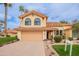 Charming two-story home featuring a well-manicured lawn, desert landscaping, and a two-car garage at 11731 N 91St Pl, Scottsdale, AZ 85260