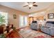 Open living room with hardwood floors and access to kitchen and outdoor patio at 11731 N 91St Pl, Scottsdale, AZ 85260