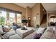 Bright living room features high ceilings, large windows, and an adjacent staircase at 11731 N 91St Pl, Scottsdale, AZ 85260