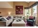 Cozy living room features a vaulted ceiling, comfortable seating, and natural light at 11731 N 91St Pl, Scottsdale, AZ 85260