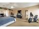 Large main bedroom complete with a ceiling fan, TV, dresser, treadmill and stationary bike at 11731 N 91St Pl, Scottsdale, AZ 85260