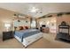 Spacious main bedroom with a ceiling fan, large bed, and a treadmill for a home gym at 11731 N 91St Pl, Scottsdale, AZ 85260