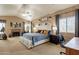 Comfortable bedroom with a cozy fireplace, seating area, and a large bed with stylish decor at 11731 N 91St Pl, Scottsdale, AZ 85260