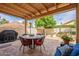 Covered patio with dining table, seating, and grill, creating an ideal outdoor space at 11731 N 91St Pl, Scottsdale, AZ 85260