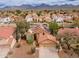 Aerial view of home with solar panels in residential community with mountain backdrop at 13383 N 101St Way, Scottsdale, AZ 85260