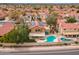 Aerial shot of a house showing a backyard pool, a covered patio, an outdoor kitchen, and solar panels at 13383 N 101St Way, Scottsdale, AZ 85260