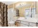 Bathroom featuring tile shower, vanity, and a large mirror in neutral tones at 13383 N 101St Way, Scottsdale, AZ 85260