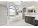 Bright bathroom featuring a soaking tub, tiled floors, and modern fixtures at 13383 N 101St Way, Scottsdale, AZ 85260