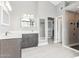Bright bathroom featuring white countertops, gray cabinets, walk in shower at 13383 N 101St Way, Scottsdale, AZ 85260