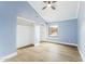 Bedroom featuring a ceiling fan, wood floor, two closets, and a large window at 13383 N 101St Way, Scottsdale, AZ 85260