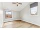 Cozy bedroom with vaulted ceilings, wood floor, and windows overlooking the neighborhood at 13383 N 101St Way, Scottsdale, AZ 85260