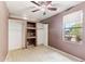 Bedroom with a ceiling fan, closet, and a large window with neighborhood views at 13383 N 101St Way, Scottsdale, AZ 85260