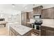 Spacious eat-in kitchen featuring wood floors, stainless appliances, and granite countertops at 13383 N 101St Way, Scottsdale, AZ 85260