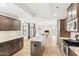 Open kitchen layout featuring an island, granite countertops, stainless appliances, and wood floors at 13383 N 101St Way, Scottsdale, AZ 85260