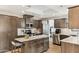Well-equipped kitchen boasts stainless appliances, granite counters, island and wood cabinets at 13383 N 101St Way, Scottsdale, AZ 85260