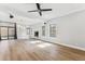 Spacious living room with wood floors, fireplace, and sliding glass door at 13383 N 101St Way, Scottsdale, AZ 85260