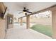 Inviting covered patio with a ceiling fan overlooking the pool and backyard at 13383 N 101St Way, Scottsdale, AZ 85260