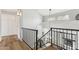Bright staircase with black iron railing overlooking the living room and foyer at 13383 N 101St Way, Scottsdale, AZ 85260