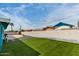 Lovely backyard with synthetic grass, a stucco wall, and a view of the neighborhood at 1340 E Golden Ln, Phoenix, AZ 85020