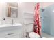 Compact bathroom features a single sink vanity, toilet, and enclosed shower with blue tile at 1340 E Golden Ln, Phoenix, AZ 85020