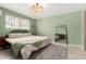 Serene bedroom featuring a comfortable bed, stylish rug, and decorative macrame wall hanging at 1340 E Golden Ln, Phoenix, AZ 85020