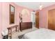 Pink bedroom featuring wooden furniture, decor, and natural lighting at 1340 E Golden Ln, Phoenix, AZ 85020