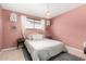 Bright pink bedroom with unique decor, chandelier, and cozy rug at 1340 E Golden Ln, Phoenix, AZ 85020