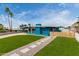 Charming blue home featuring a walkway with stone pavers, lush green lawn, and palm trees at 1340 E Golden Ln, Phoenix, AZ 85020