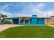 Striking blue home with a modern design, large windows, and a well-manicured lawn at 1340 E Golden Ln, Phoenix, AZ 85020