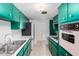 Bright kitchen featuring teal cabinets, stainless appliances, and retro oven at 1340 E Golden Ln, Phoenix, AZ 85020