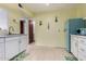 Open kitchen features white cabinets, tile floors, and unique blue refrigerator at 1340 E Golden Ln, Phoenix, AZ 85020