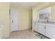 Bright kitchen features white cabinets, modern faucet, and neutral tile flooring at 1340 E Golden Ln, Phoenix, AZ 85020