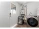Laundry area with modern washer/dryer, mini fridge, and exterior access at 1340 E Golden Ln, Phoenix, AZ 85020