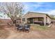Large backyard with a covered patio, outdoor furniture, and shed at 16268 W Cortez St, Surprise, AZ 85379