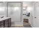 Modern bathroom featuring large walk-in shower, updated vanity and flooring at 16268 W Cortez St, Surprise, AZ 85379